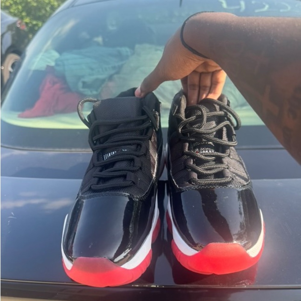 Jordan Bred 11s | Black and Red High-Top Sneakers - Picture 2 of 4